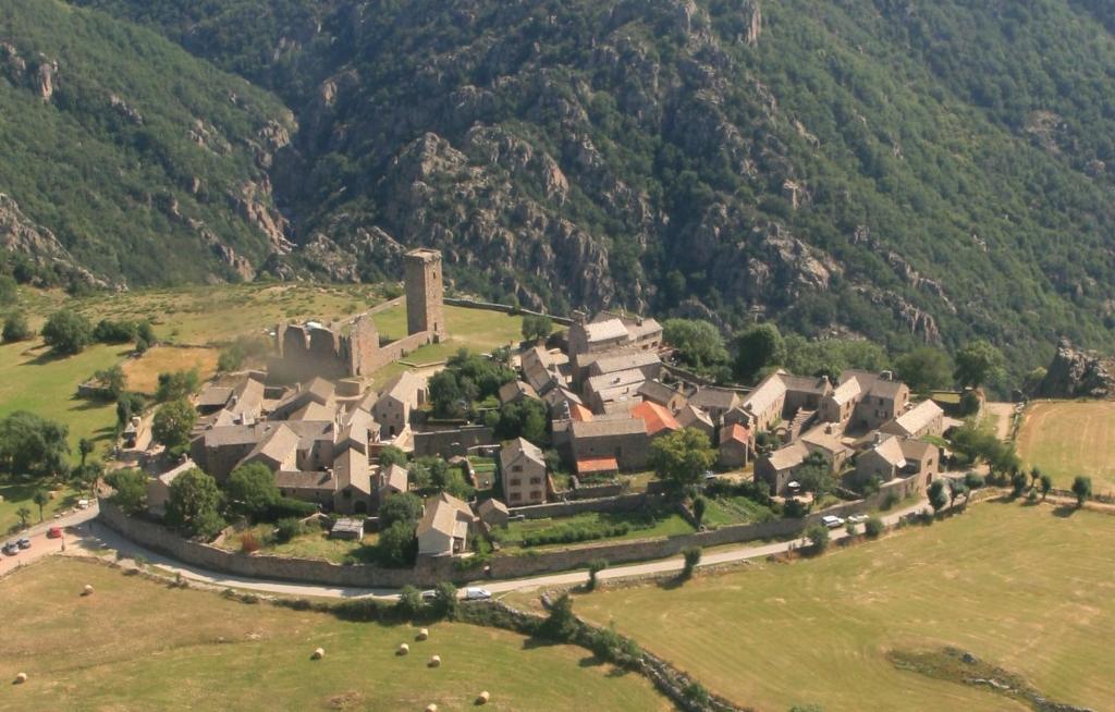 an aerial view of a large house in the mountains at gîte de la garde in Prévenchères