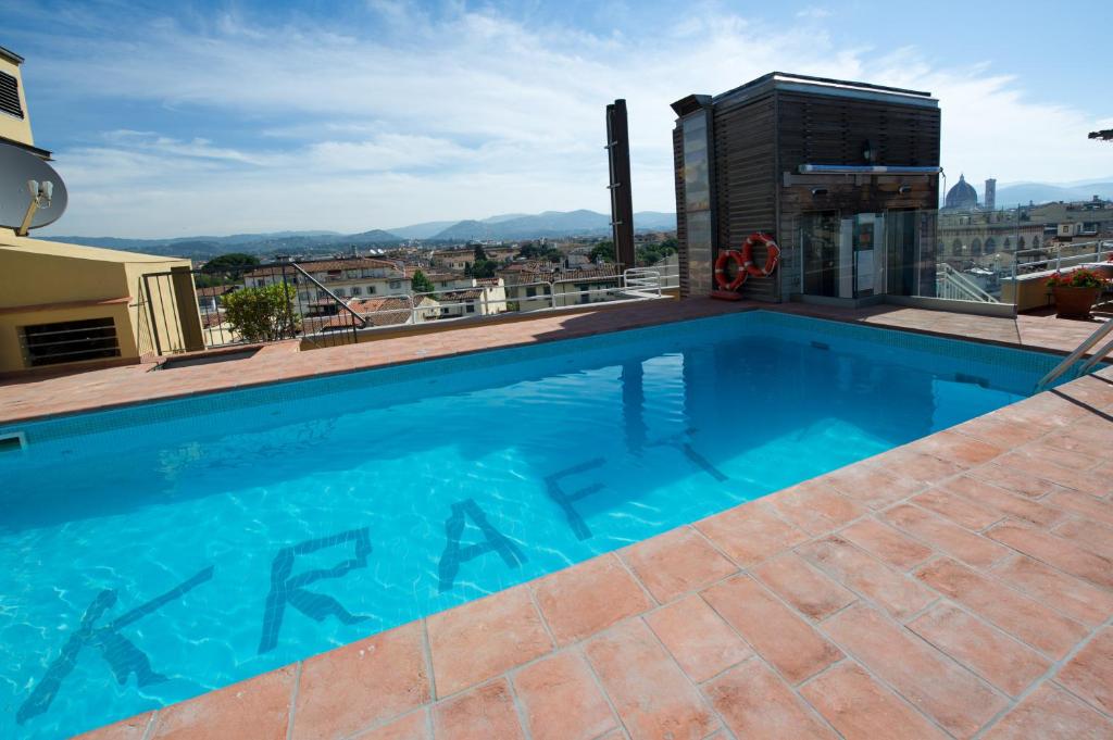 a swimming pool on the roof of a building at Hotel Kraft in Florence