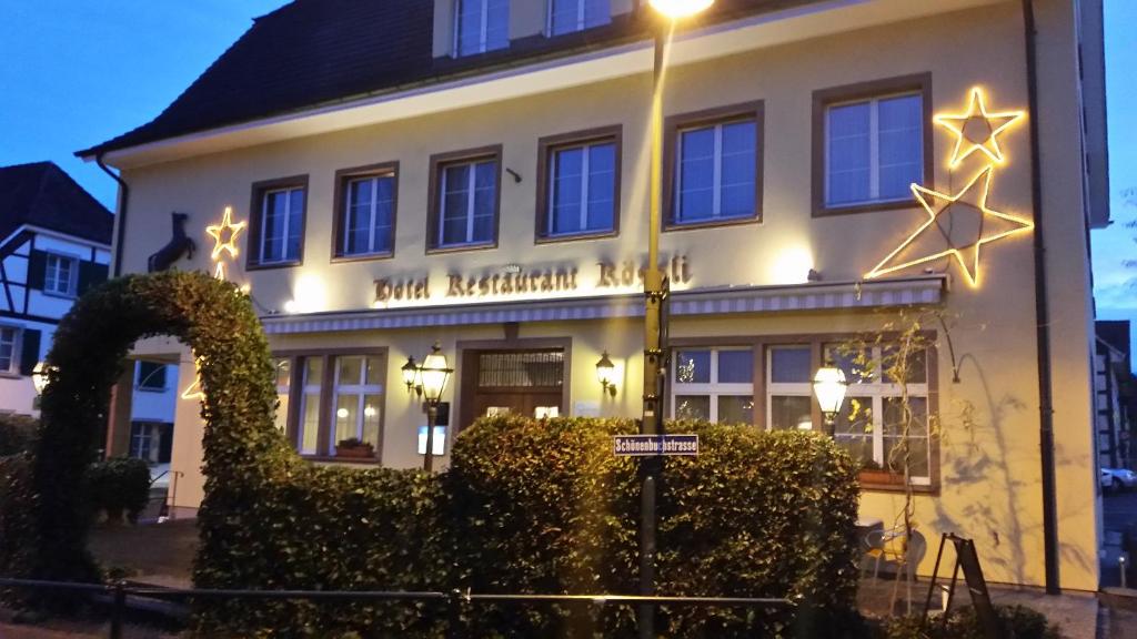 a building with a street light in front of it at Hotel Rössli in Basel