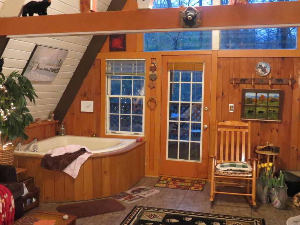 a large bathroom with a tub and windows at Buckberry Creek Chalet in Gatlinburg
