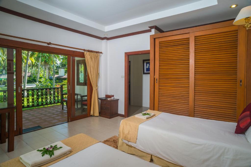 Postel nebo postele na pokoji v ubytování Am Samui Resort Taling Ngam