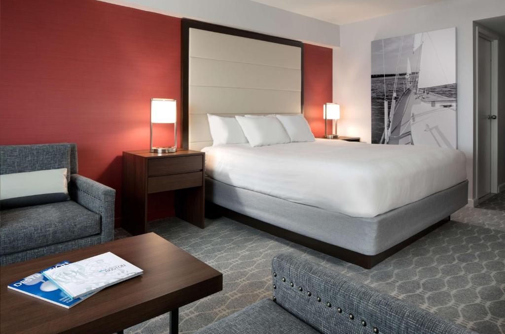 a hotel room with a bed and a chair at Hyatt Regency Boston Harbor in Boston