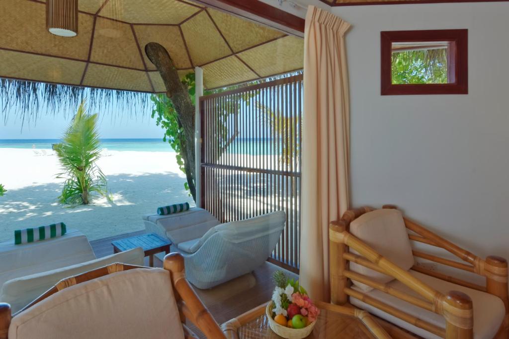 a living room with a view of the beach at Thulhagiri Island Resort & Spa in North Male Atoll