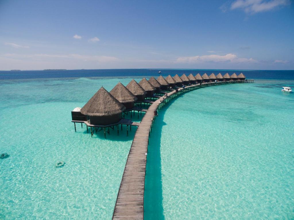 a pathway in the ocean with overwater bungalows at Thulhagiri Island Resort & Spa in North Male Atoll