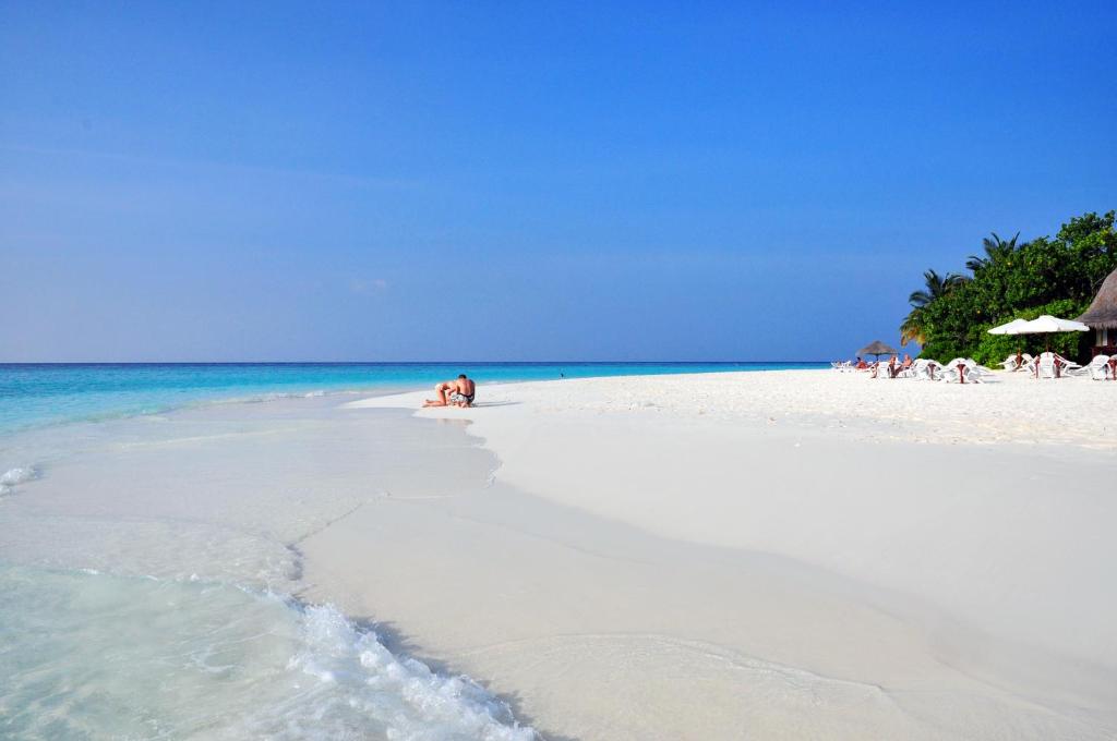 a group of people on a white beach at Thulhagiri Island Resort & Spa in North Male Atoll