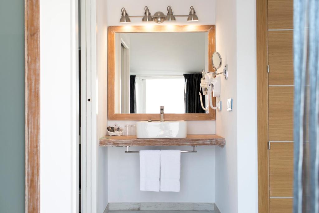 a bathroom with a sink and a mirror at Hotel Plaza Cavana in Nerja