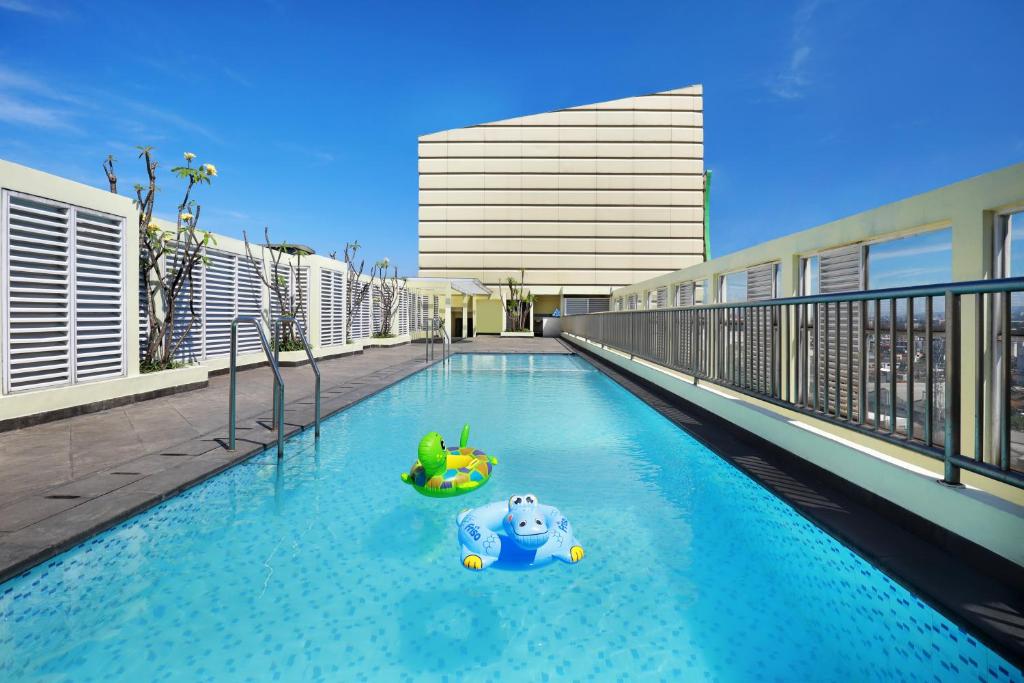a pool with a toy in the middle of a building at KIMAYA Braga Bandung by HARRIS in Bandung