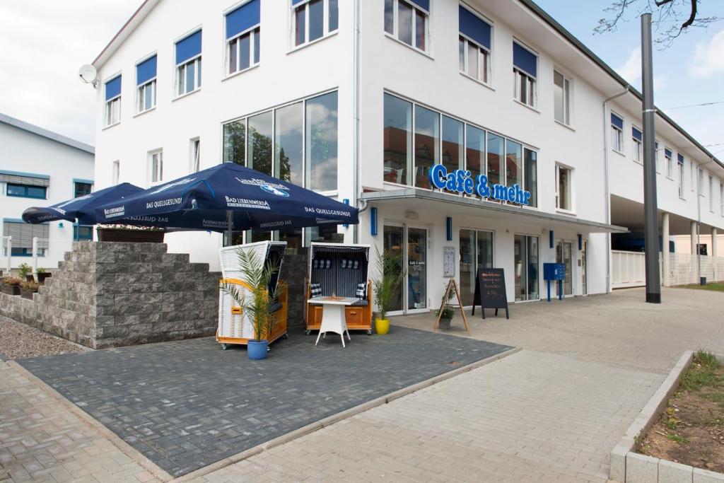 a large white building with an umbrella in front of it at Café & mehr in Halle an der Saale