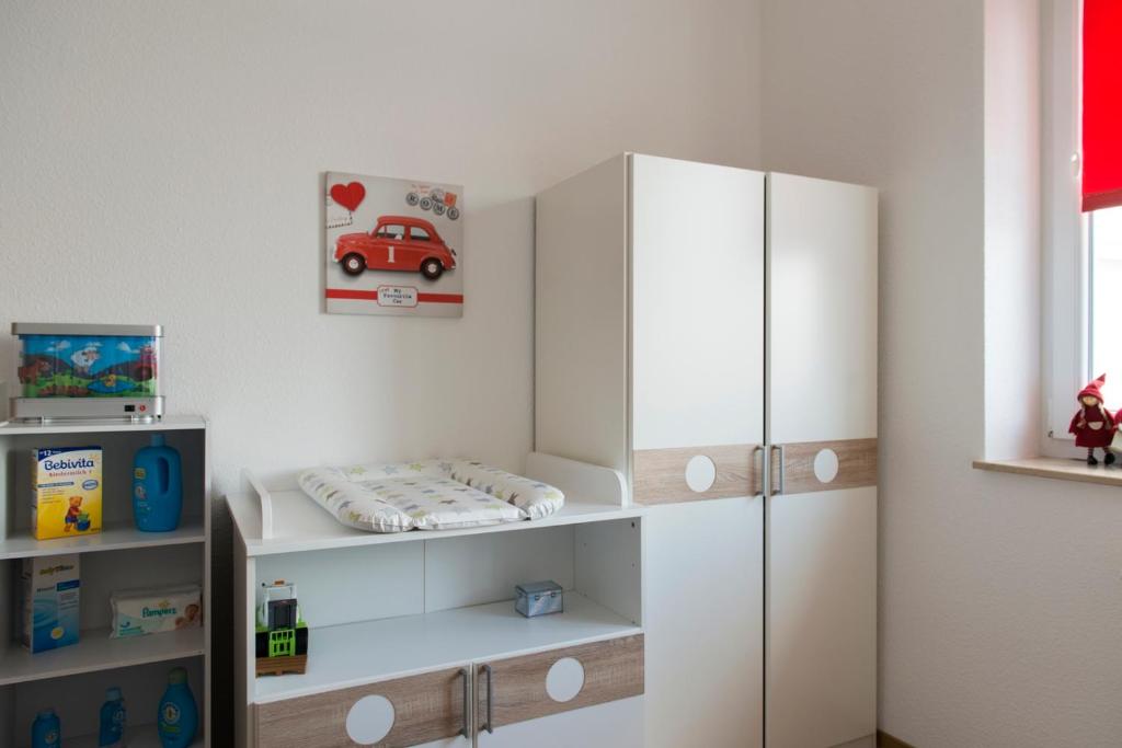 a childs room with a white cabinet and a bed at Café & mehr in Halle an der Saale