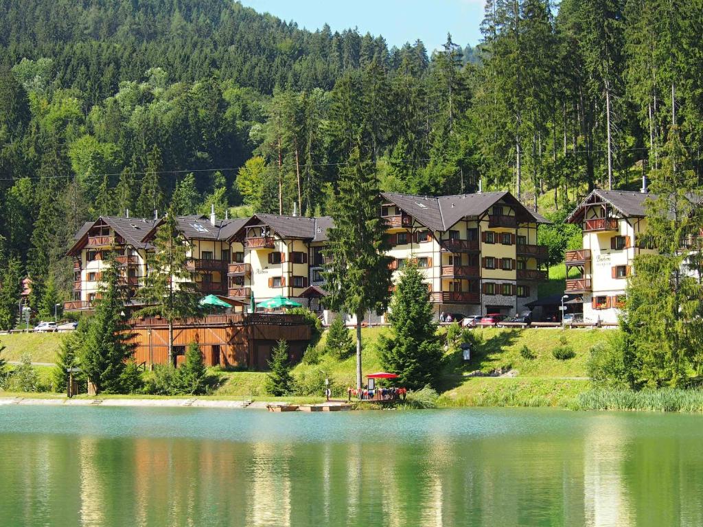 a group of condos on the side of a lake at Helena 11 in Ružomberok