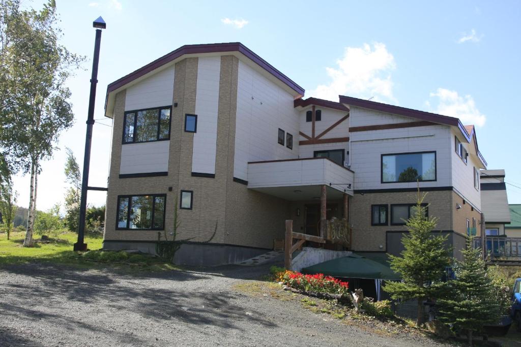 a large building with a lot of windows on it at Pension Ashitaya in Furano