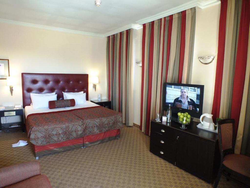 Postel nebo postele na pokoji v ubytování Prima Kings Hotel
