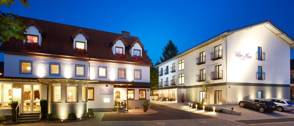 a group of buildings with cars parked in a parking lot at Hotel & Restaurant Wilder Mann in Aalen