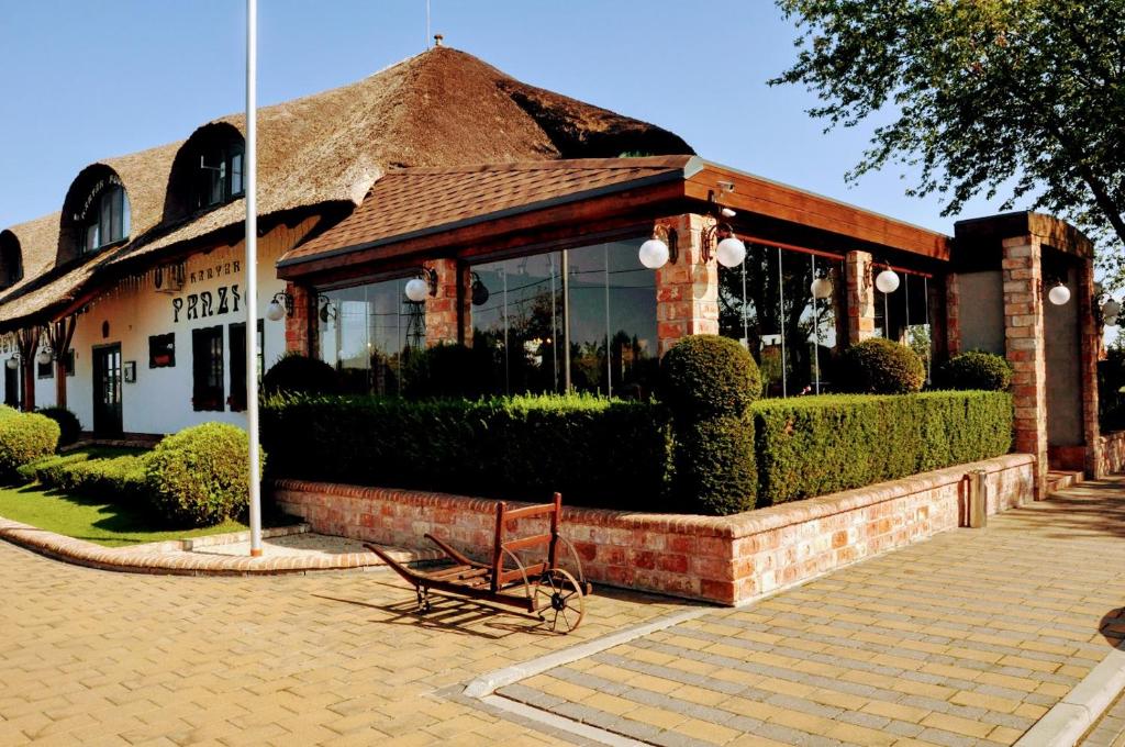 a bench sitting in front of a building at Kantár Fogadó és Étterem in Vitnyéd