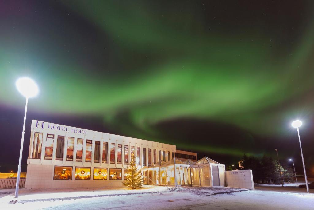 an office building with the aurora in the sky at Hotel Höfn in Höfn