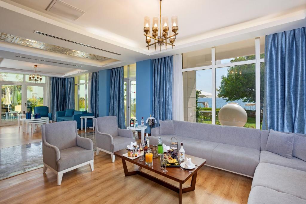 a living room with a couch and chairs and a table at Sherwood Exclusive Kemer - Kids Concept in Kemer
