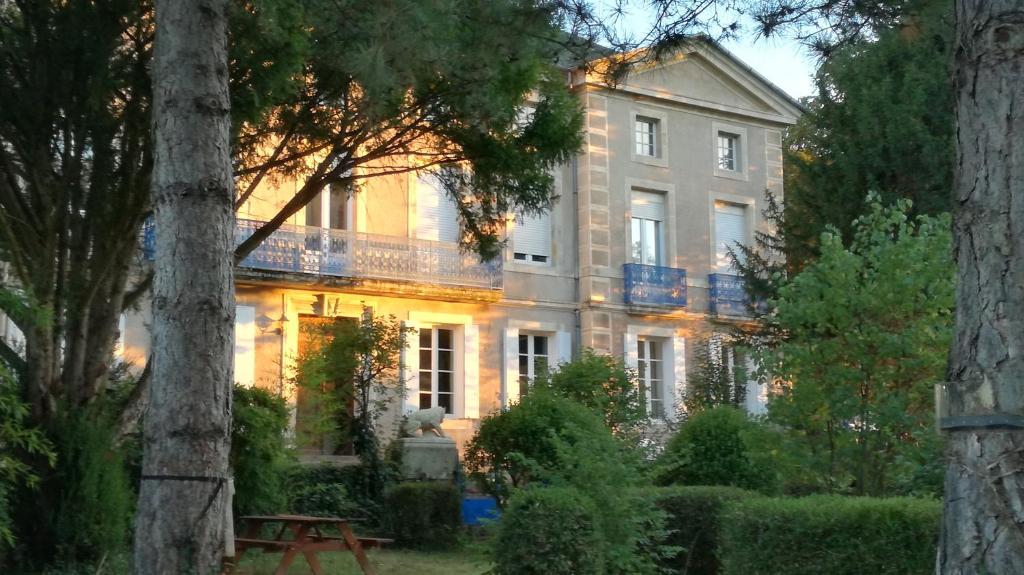 a large white house with trees in front of it at Domaine du Vern in Saint-Affrique