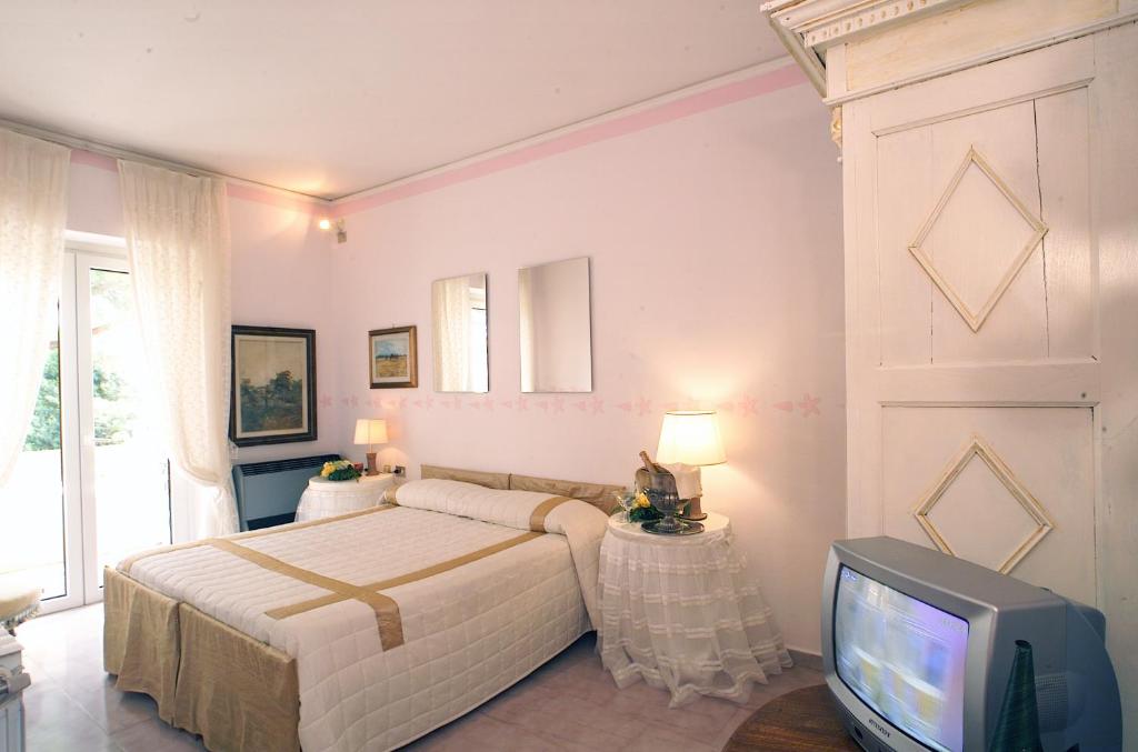 Postel nebo postele na pokoji v ubytování Hotel Velcamare