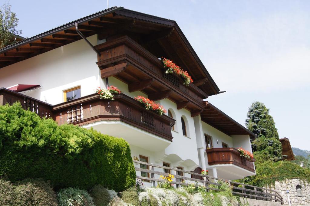 a building with flower boxes on the balconies at Ferienwohnungen Familie Rieder in Kaltenbach