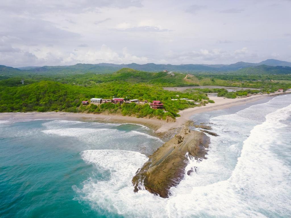 an aerial view of a beach and the ocean at Magnific Rock - Surf Resort & Yoga Retreat Nicaragua in Popoyo