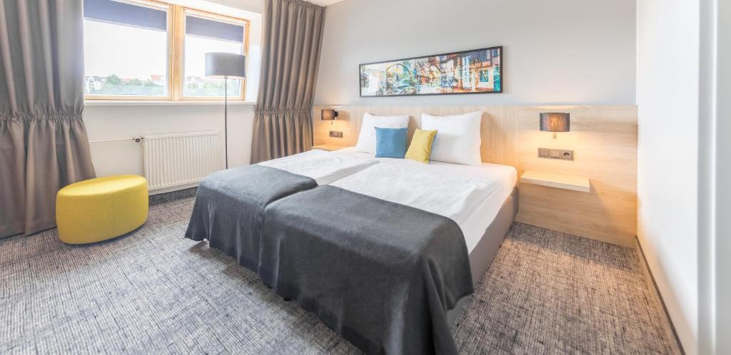 Postel nebo postele na pokoji v ubytování Ramada by Wyndham Flensburg City