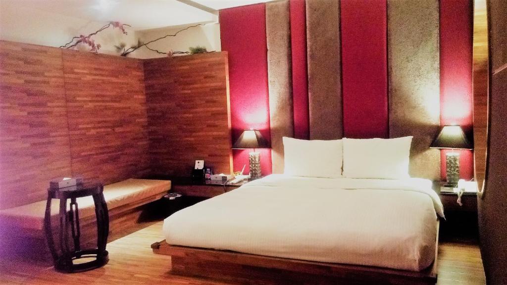 Postel nebo postele na pokoji v ubytování Her Home Spa Motel Xinying