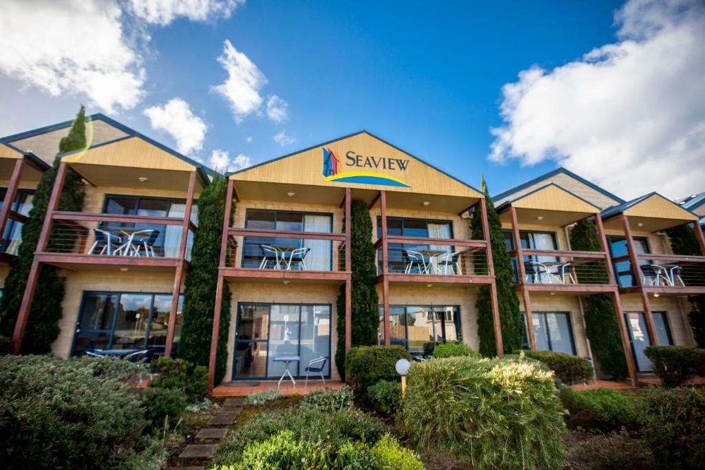 a resort building with tables and chairs on the balconies at Seaview Motel & Apartments in Apollo Bay
