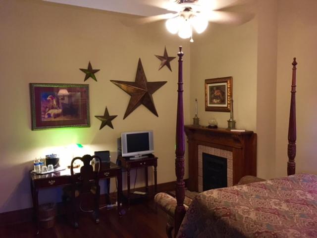 a bedroom with a bed and stars on the wall at 1896 O'Malley House in New Orleans