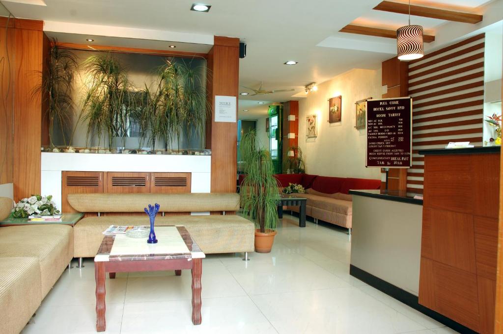a lobby with couches and tables in a restaurant at Hotel Imperial Classic in Hyderabad