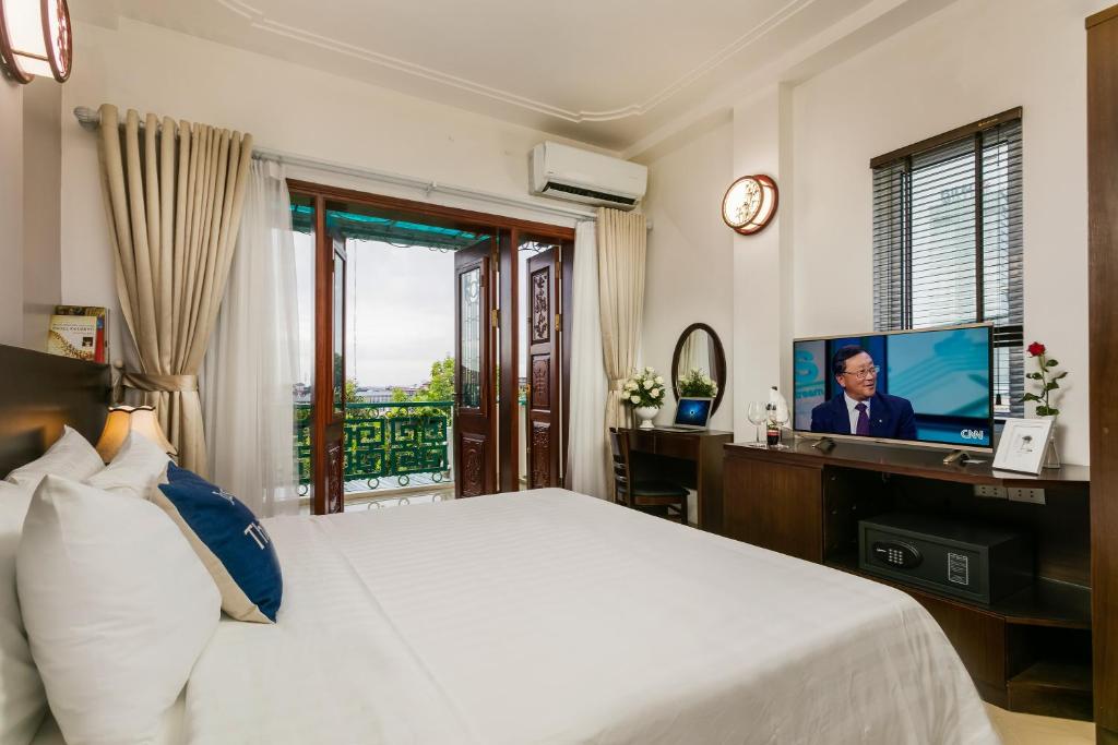 Postel nebo postele na pokoji v ubytování Hanoi Stella Hotel