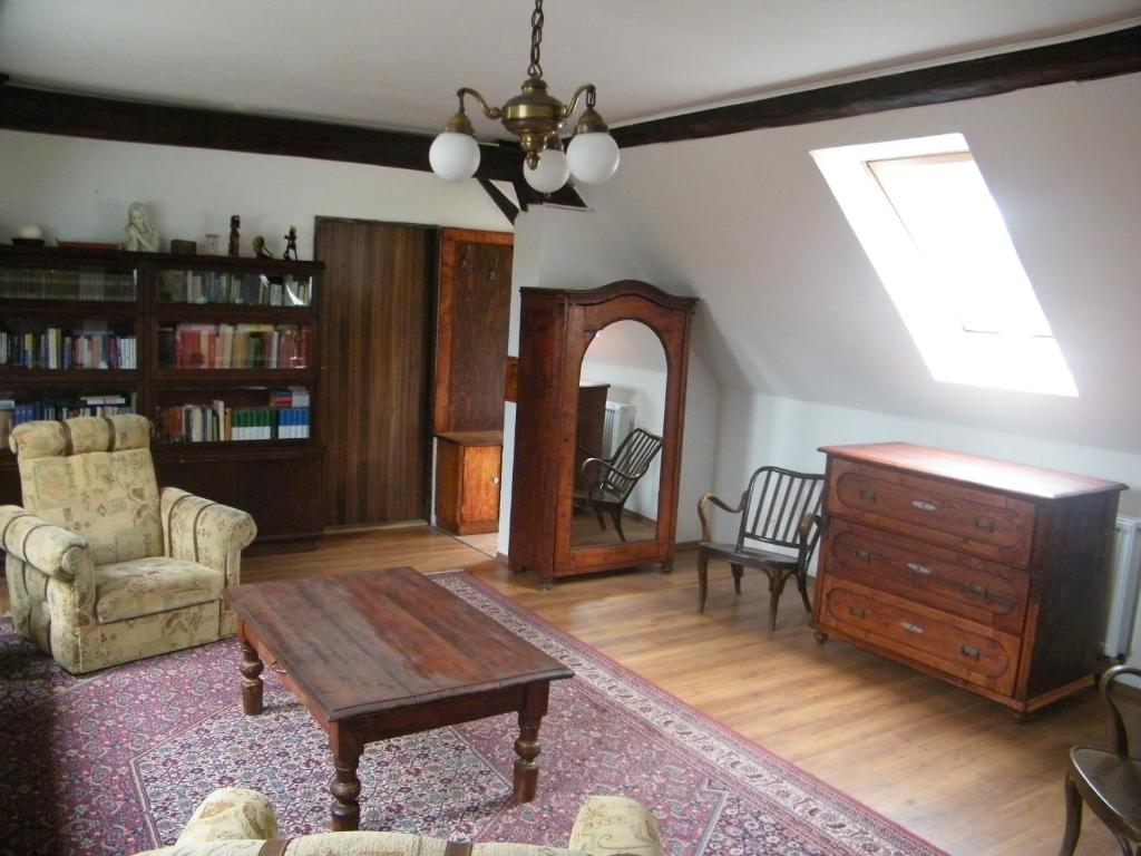 a living room with a table and a dresser at U Slunce in Ostředek
