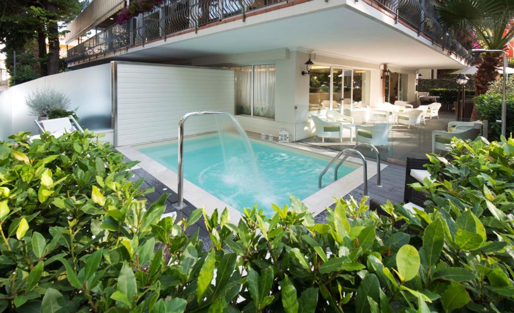 a swimming pool in the backyard of a house at Atlas Hotel in Riccione