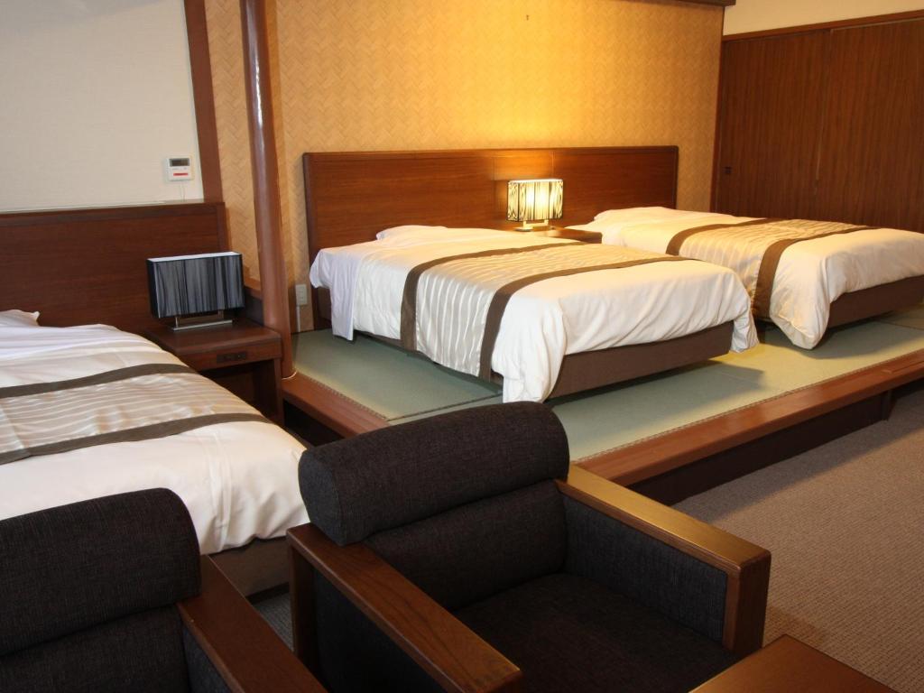 Postel nebo postele na pokoji v ubytování Misasa Royal Hotel
