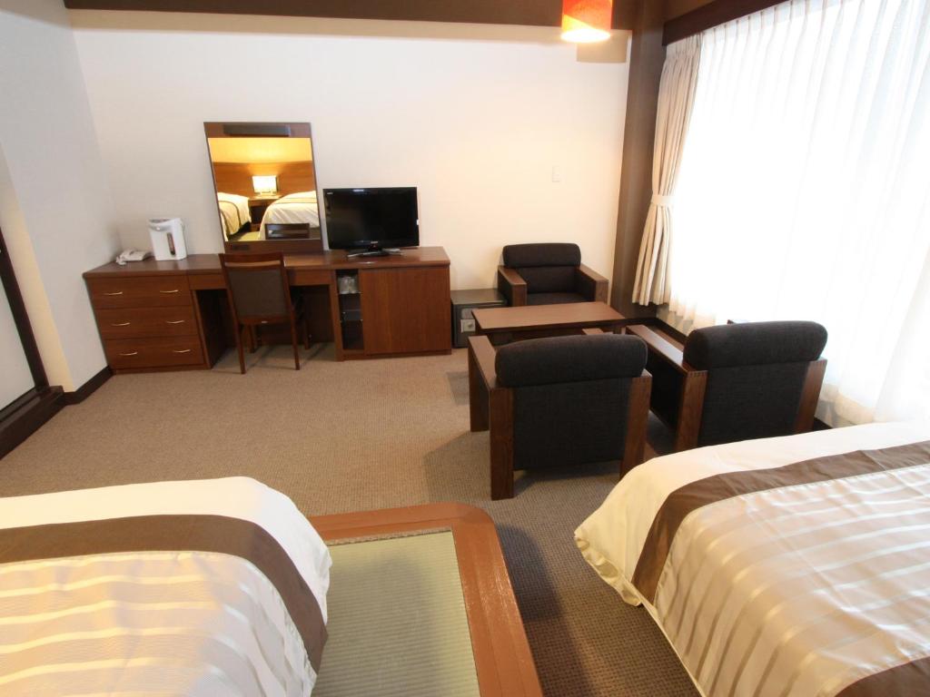 Postel nebo postele na pokoji v ubytování Misasa Royal Hotel