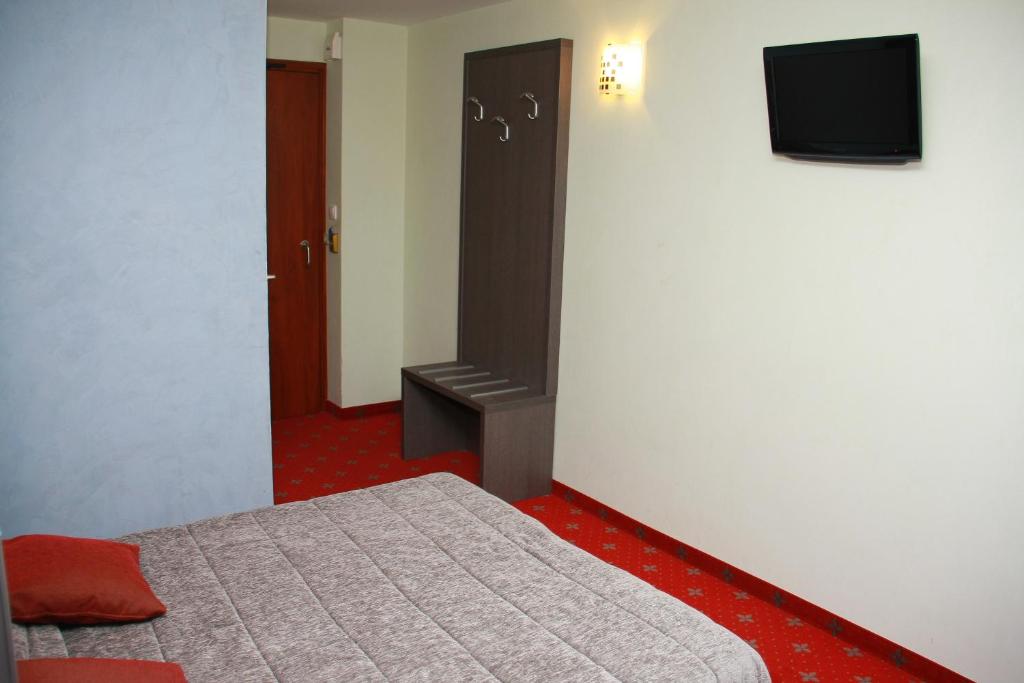 Postel nebo postele na pokoji v ubytování Hôtel Le Commerce