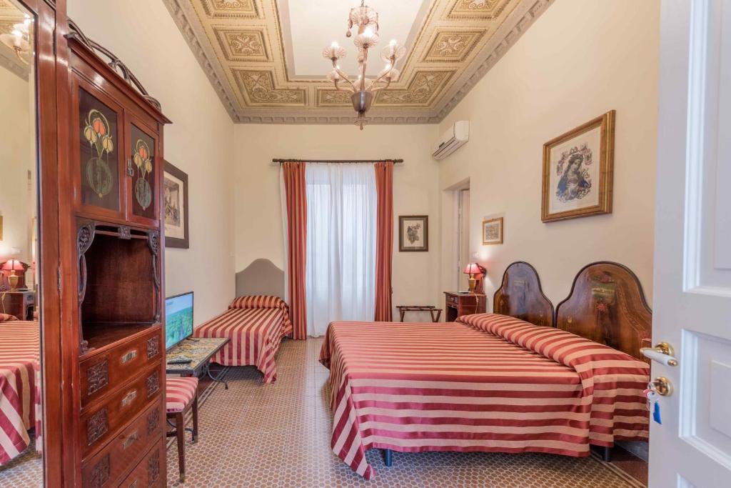 Posteľ alebo postele v izbe v ubytovaní Palazzo Benso