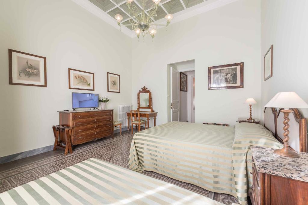 Posteľ alebo postele v izbe v ubytovaní Palazzo Benso