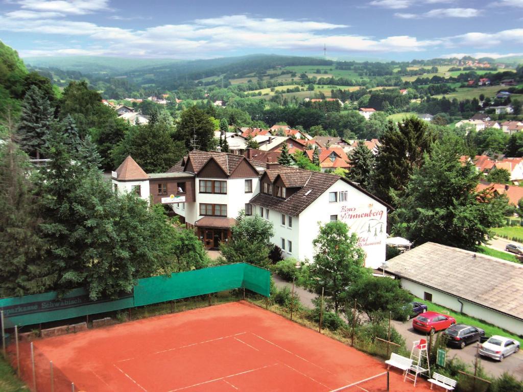 a tennis court in the middle of a town at AKZENT Hotel Haus Sonnenberg in Schotten