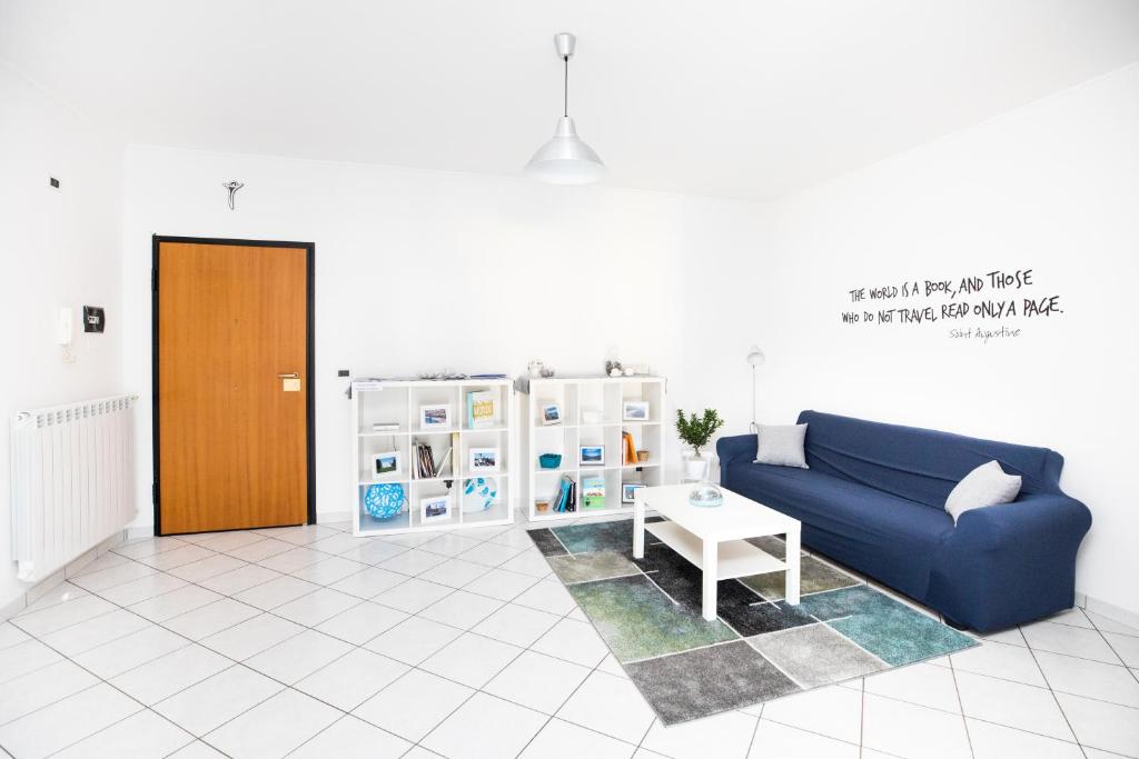 a living room with a blue couch and a table at Moi Moi B&B in LʼAquila