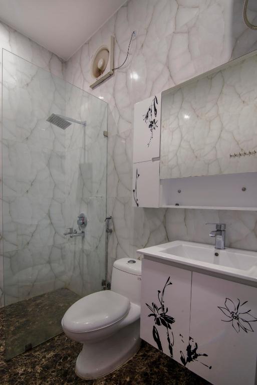 un baño con inodoro y lavabo en Tuk Tuk Homestay, en Agra