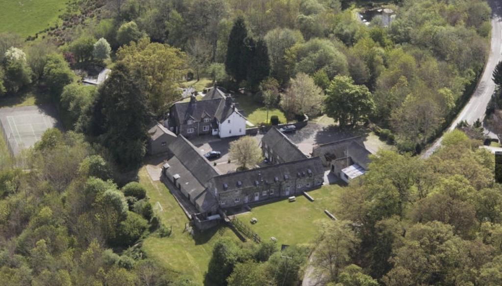 an aerial view of a large house in the forest at Bryn Melyn Farm Cottages in Bala