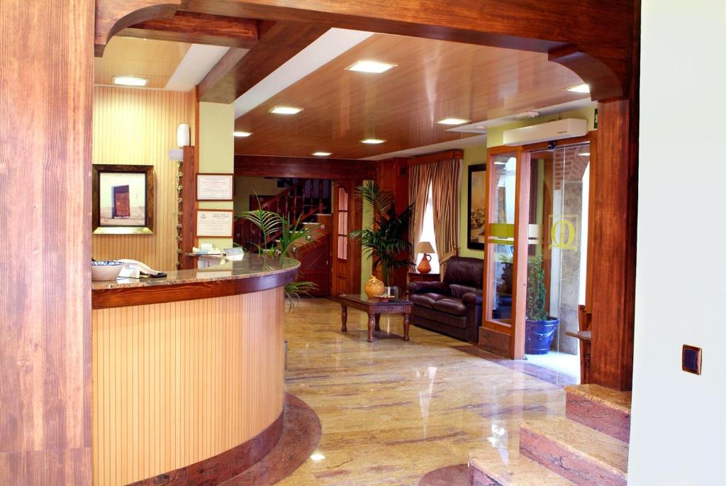 a lobby with a bar and a living room at Hotel Menano in Manzanares