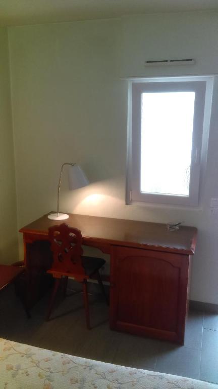 a desk with a window and a chair in a room at Hotel de l&#39;Orangerie in Strasbourg