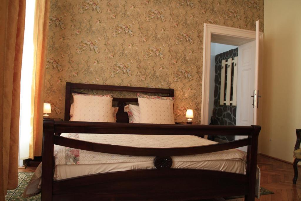 a bedroom with a wooden bed with pillows at Casa Blanca in Sibiu