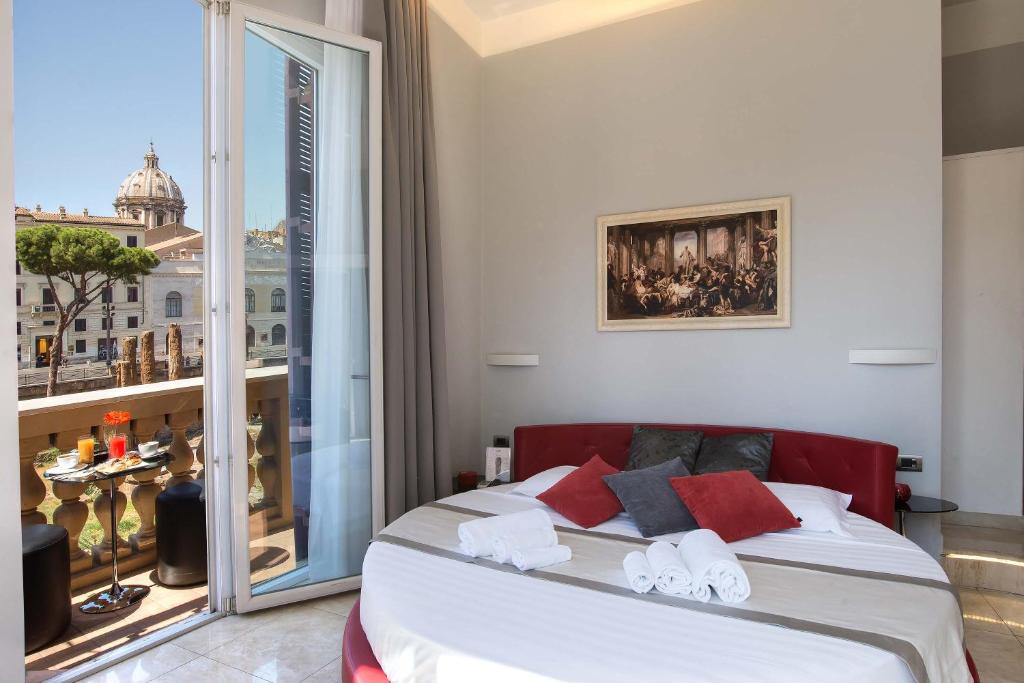 a bedroom with a bed and a large window at Pantheon Caesar Relais in Rome
