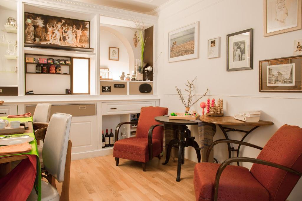 a dining room with two tables and chairs at Private room in a Parisian homestay! - Close to it all! in Paris