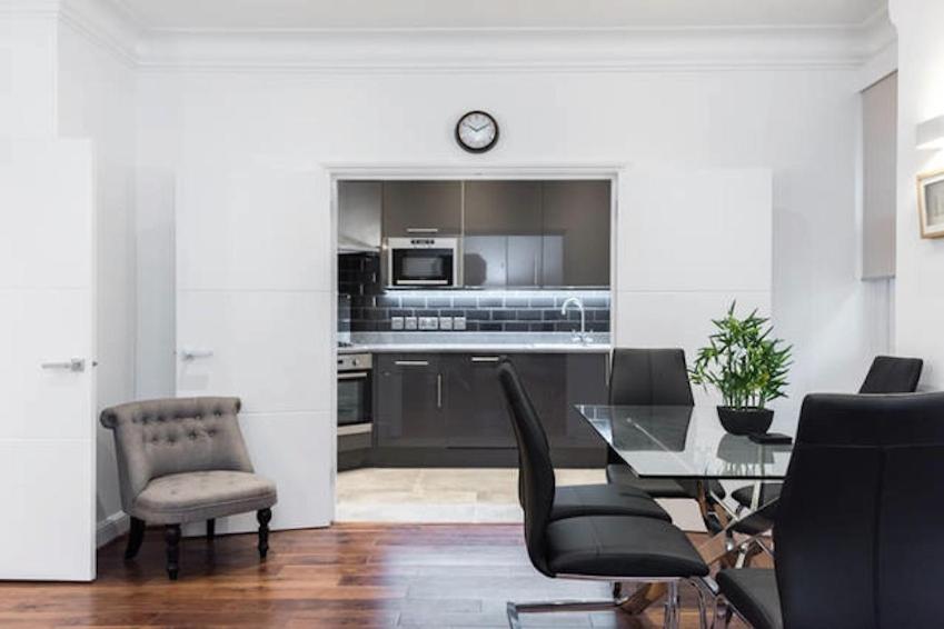 a kitchen and dining room with a table and chairs at Fleet Street Apartment 3 in London