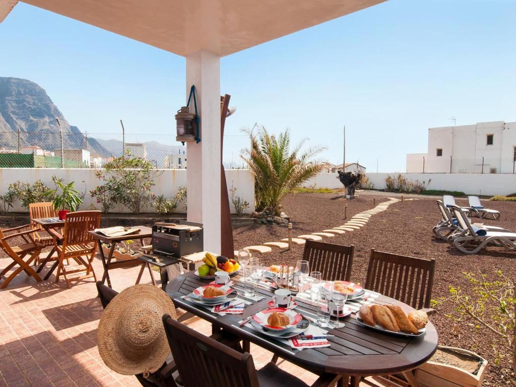 una mesa con comida en el patio en Agaete Beach Rental at Volcanic Natural Pools, en Agaete