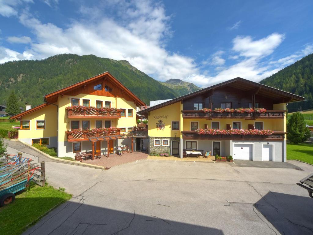 a large yellow building with flowers on the balconies at Eggerhof in Mallnitz