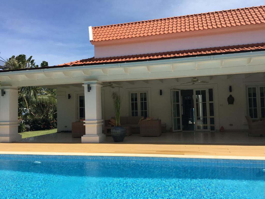 a house with a swimming pool in front of it at Balinese villa with private pool in Hua Hin